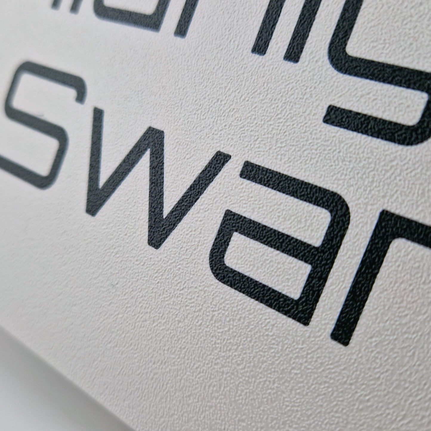 A personalised boat name printed on a dark marine instrument cover.