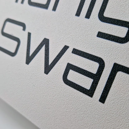 A personalised boat name printed on a dark marine instrument cover.