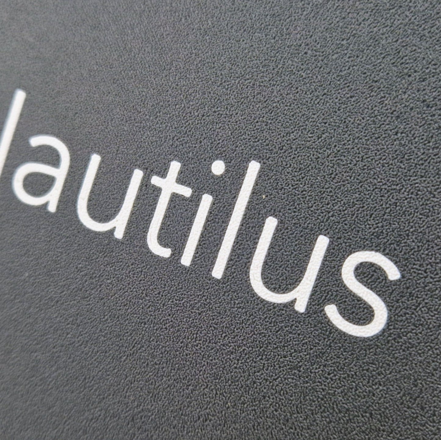 A highly detailed boat name engraved on a marine instrument suncover