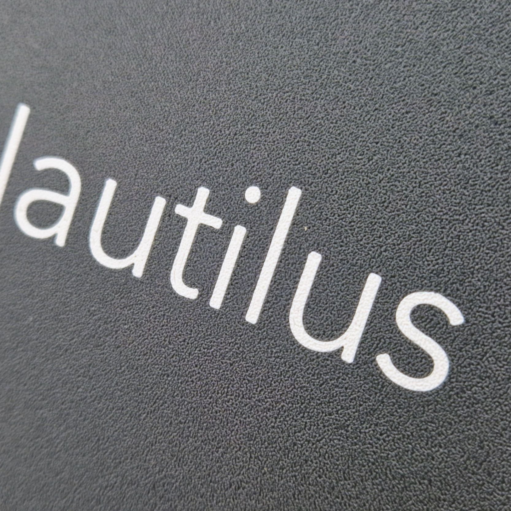A highly detailed boat name engraved on a marine instrument suncover