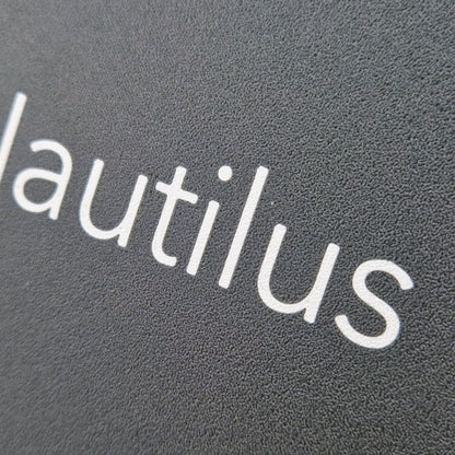 A highly detailed boat name engraved on a marine instrument suncover