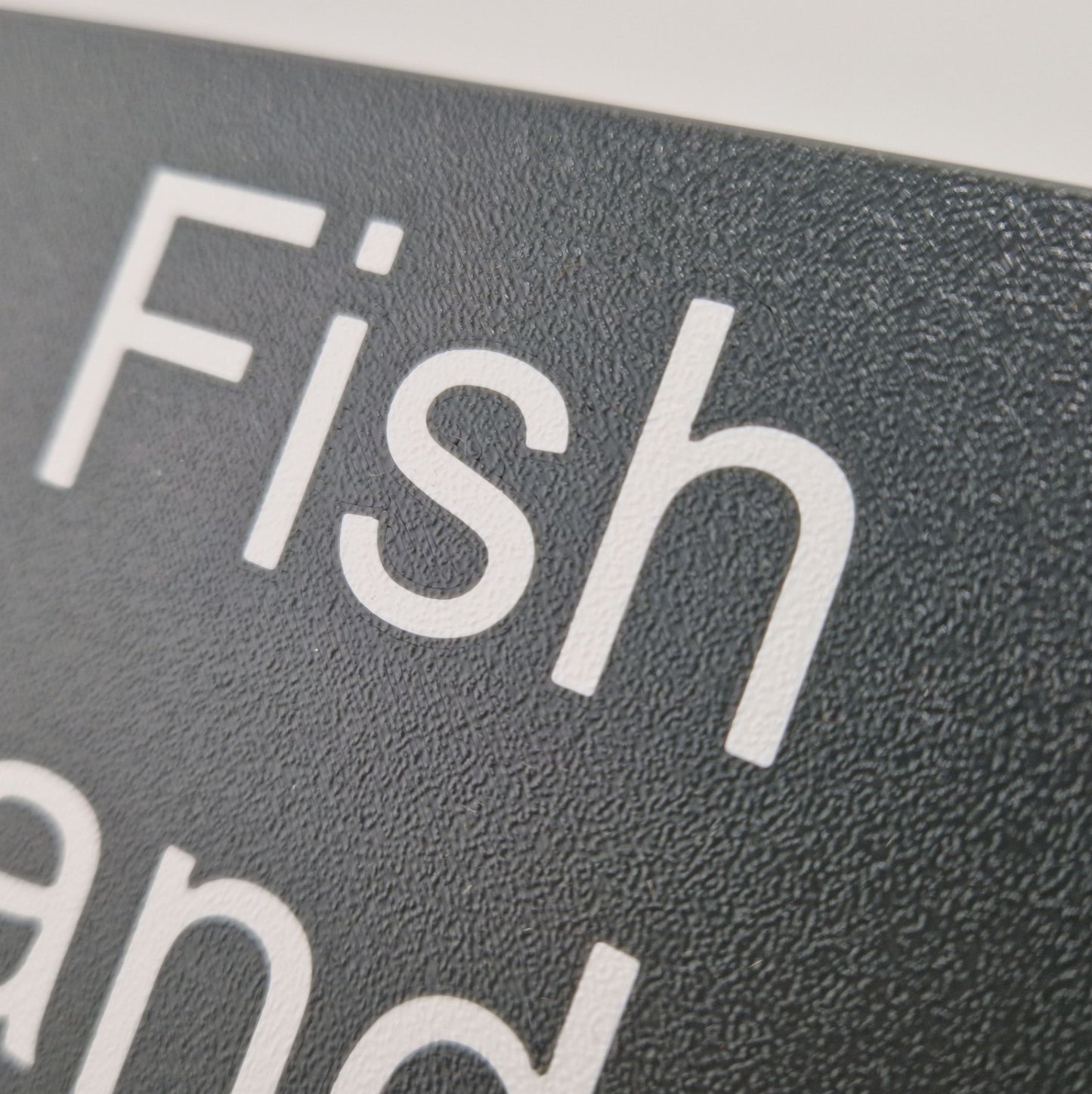 A marine instrument cover with "Fish and Chips" engraved on it.